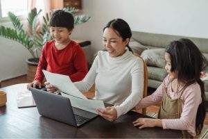 A mother doing homework with her children